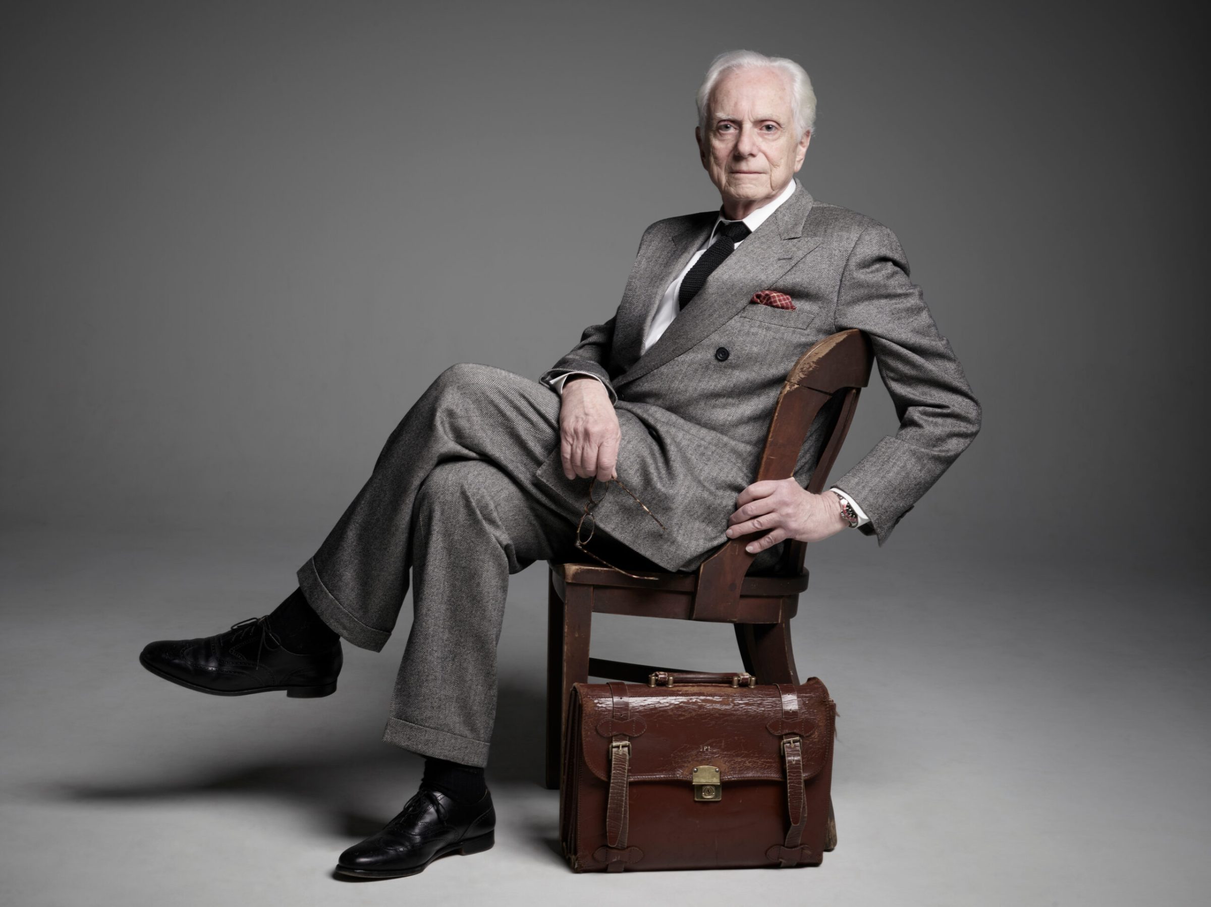 Lombardi a person sitting on a suitcase