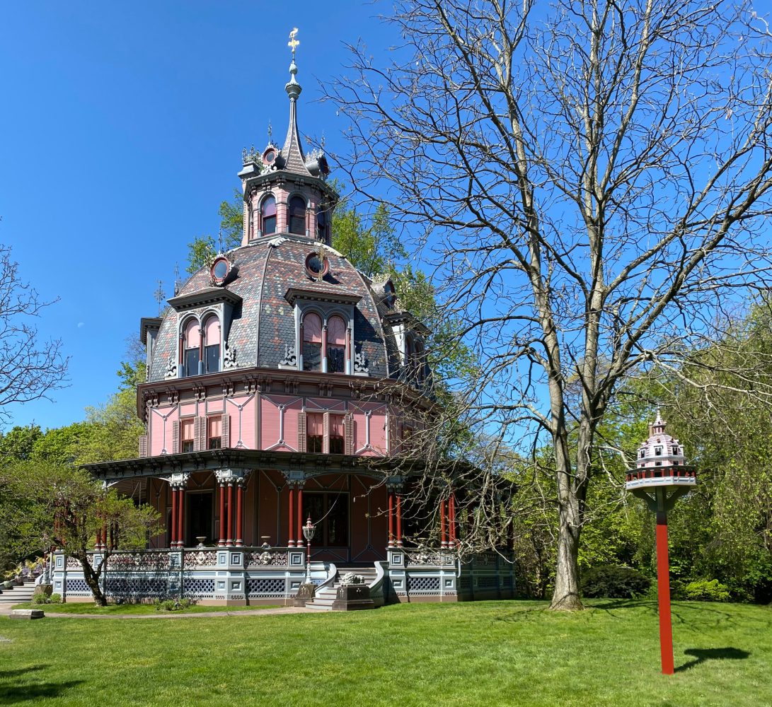 a clock tower in front of a house