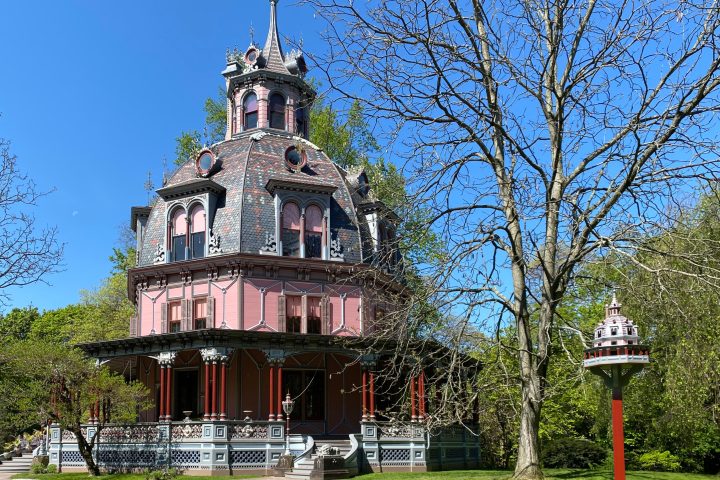 a clock tower in front of a house